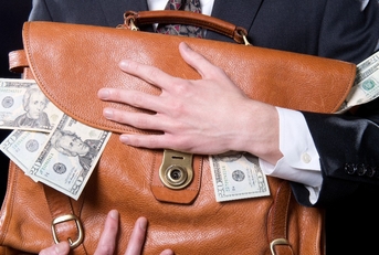 man holding briefcase with money spilling out