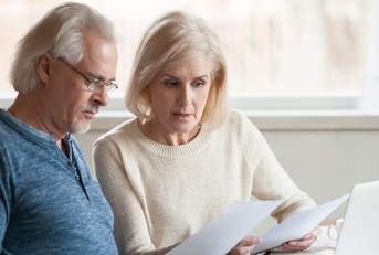 old couple reading documents