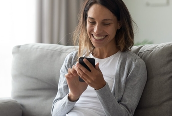 an adult woman playing a game on her phone