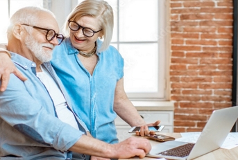 happy senior couple using laptop