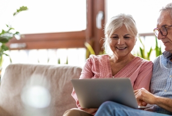 happy senior couple using laptop 
