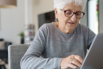 old woman at home using laptop computer
