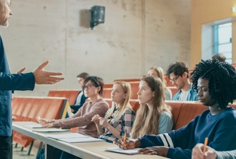 professor holding lecture to a multi ethnic group of students