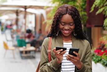 Woman using credit card on her phone
