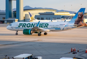 frontier airplane standing at las vegas airport during day time