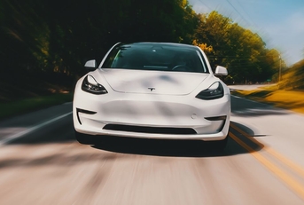 White tesla fast on the road
