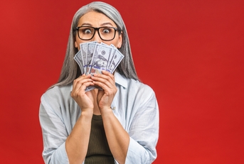senior woman holding money