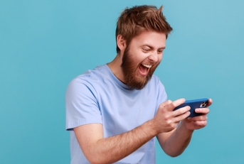 Man playing a mobile gaming app