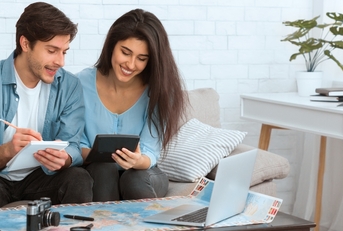 couple preparing for vacation and calculating expenses