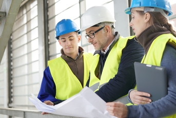 construction site manager with young people in training period