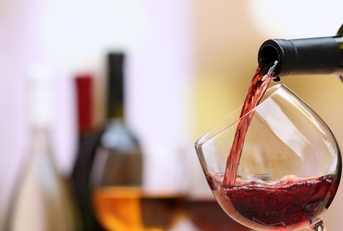 red wine pouring into wine glass
