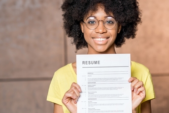 woman holding resume document indoors