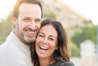 mature couple smiling while hugging each other 