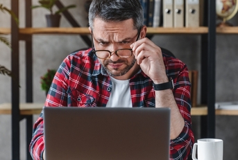 businessman in eyewear looking at computer screen