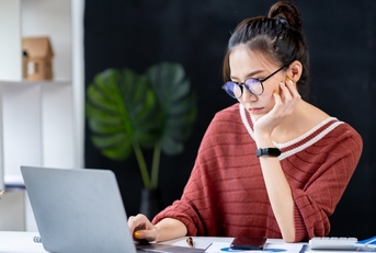 businesswoman looking at a notebook analyzing data