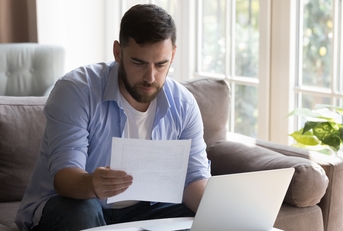 businessman doing paperwork at home