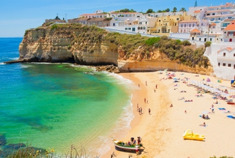 beautiful houses in line at strand algarve beach in portugal