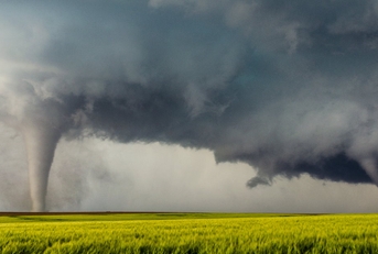 tornado in between green field