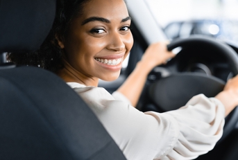 A happy woman driving a car