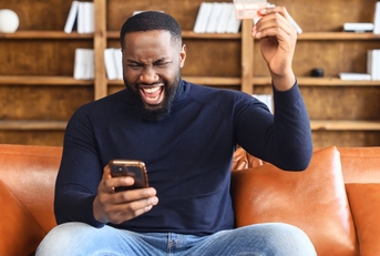 Adult man using phone apps to earn gift cards