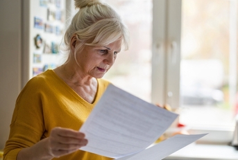 senior woman filling out financial statements