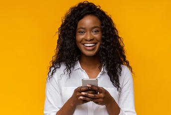 Smiling woman using phone