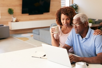 senior couple using laptop to check finances