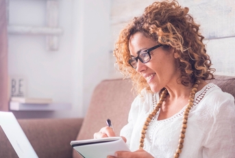 A middle-aged woman looking at computer