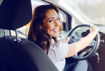Woman in driver&#x27;s seat smiling