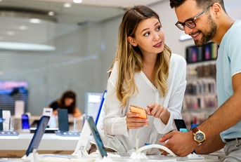 young people buying new smartphone in mobile shop