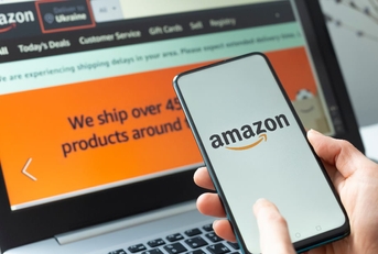 man using amazon online store app and website on laptop and smartphone