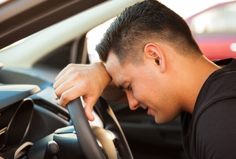 stressed young man in a car