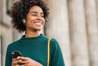Smiling woman holding phone