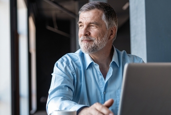 mature businessman working on laptop