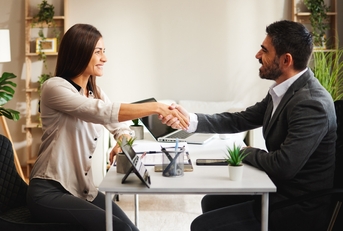 woman shakes hands with a businessman
