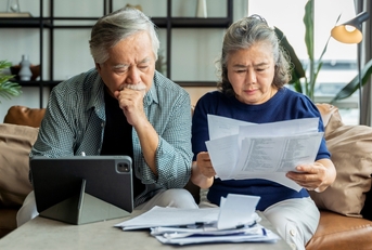 asian senior couple checking and calculate financial billing 