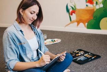 female artist drawing on a touch pad digital tablet