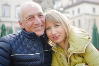 Smiling retired couple wearing winter jackets