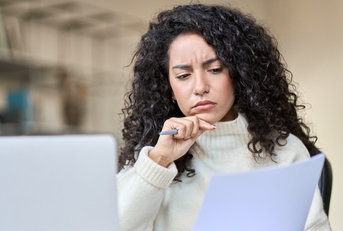 female accounting analyst checking bills