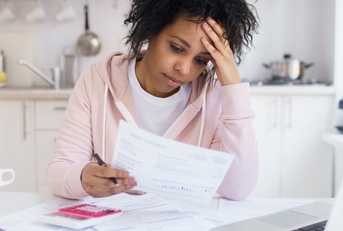 woman calculating debts feeling stressed