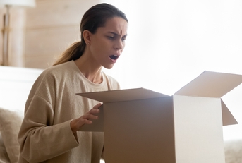annoyed woman receiving defective product 
