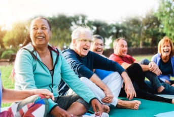 multi-ethnic seniors doing yoga in park