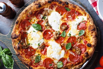 traditional italian pepperoni cheese pizza on wooden cutting board