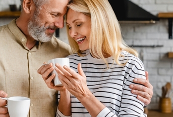 affectionate mature couple enjoying cup of coffee