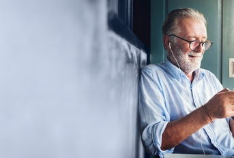 elderly man watching online movie from his phone