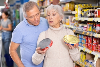 husband and wife choose canned food together