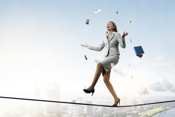 young pretty businesswoman juggling with business items
