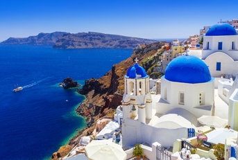 white buildings with blue domes in oia town santorini island