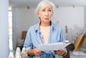 disappointed senior female designer examining room