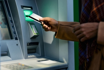 woman using atm late at night